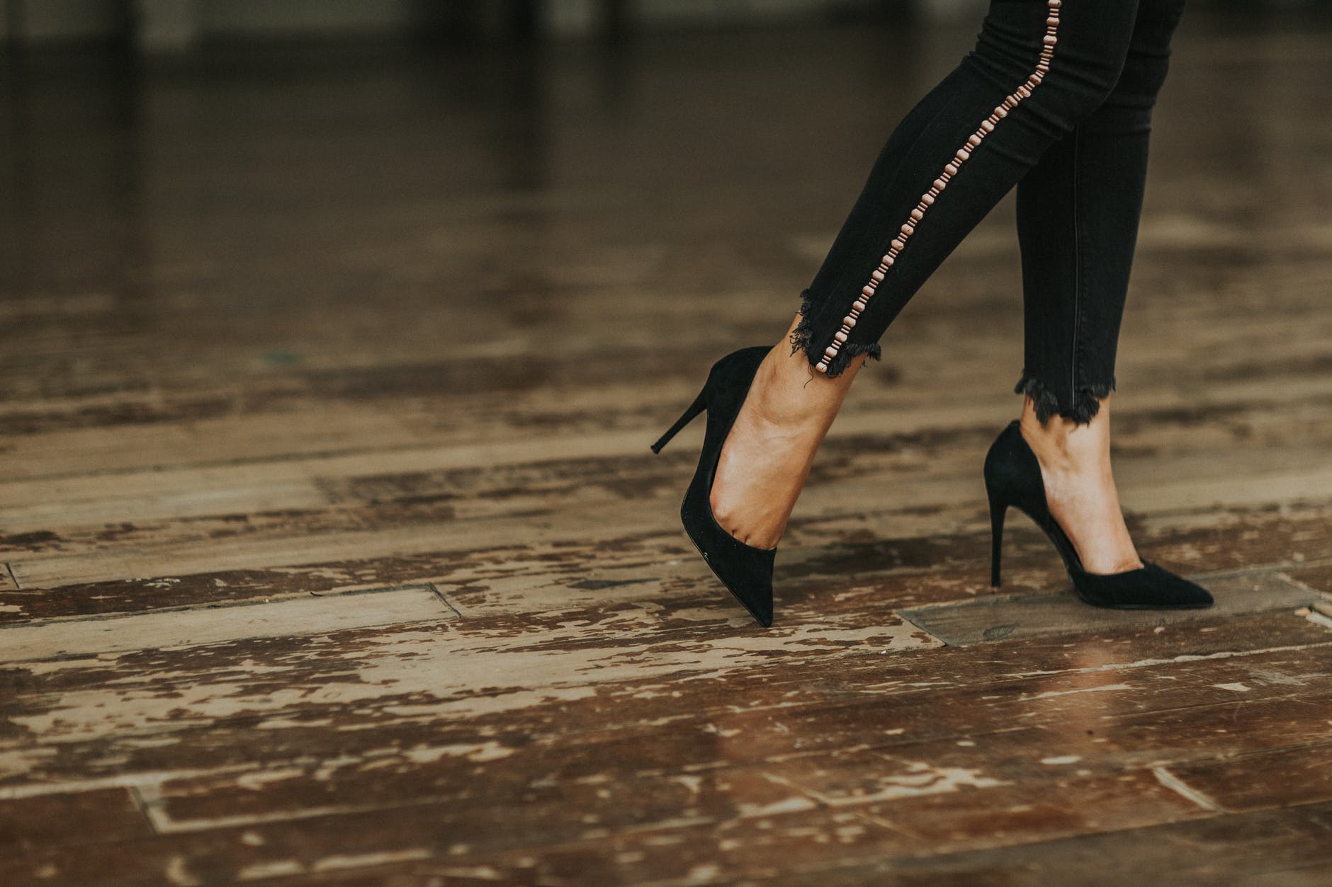 woman wearing black suede stilettos