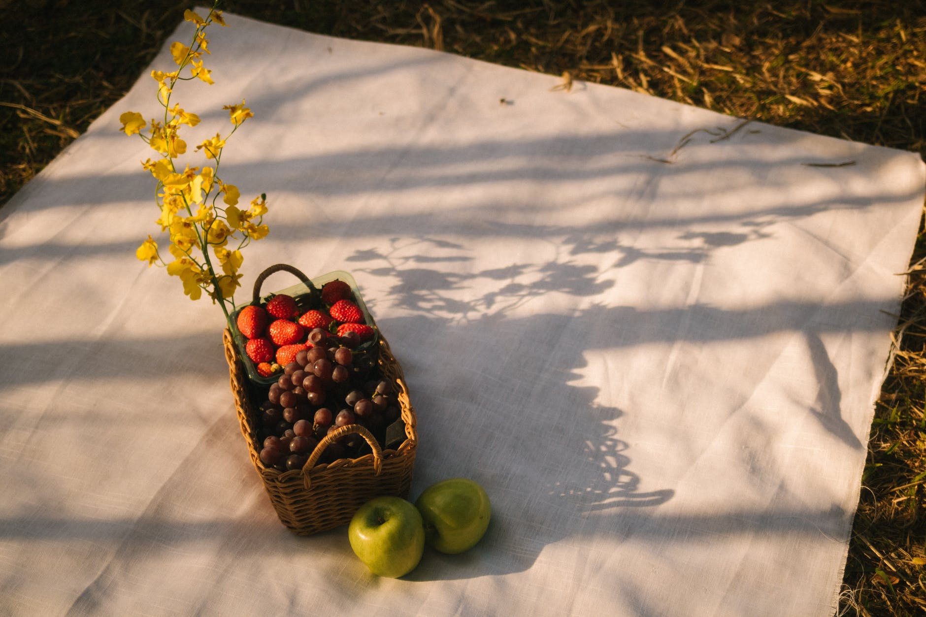 basket of fruit on white cloth