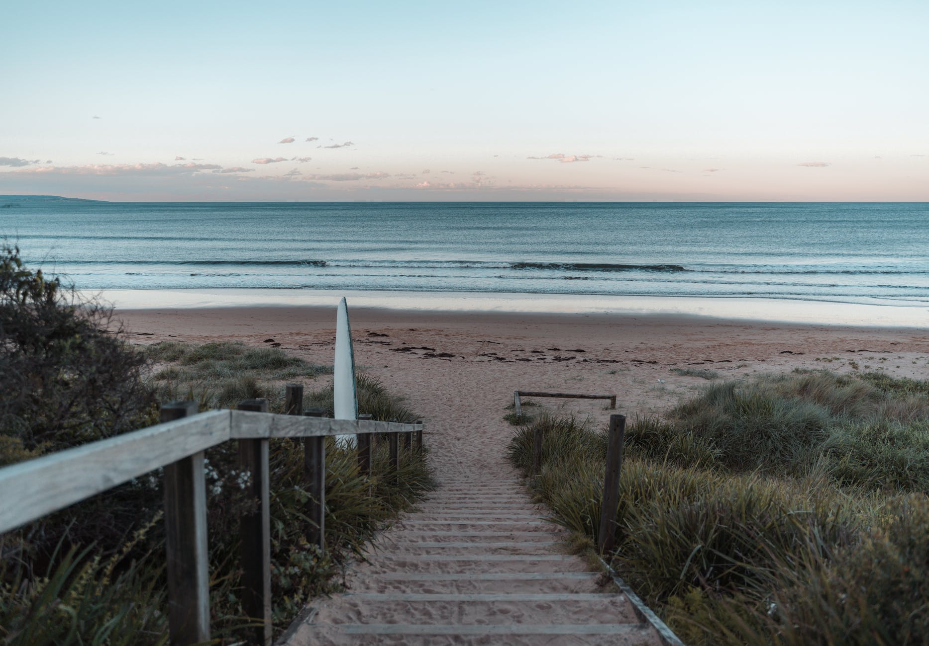 stairs covered with sand leading to peaceful beach